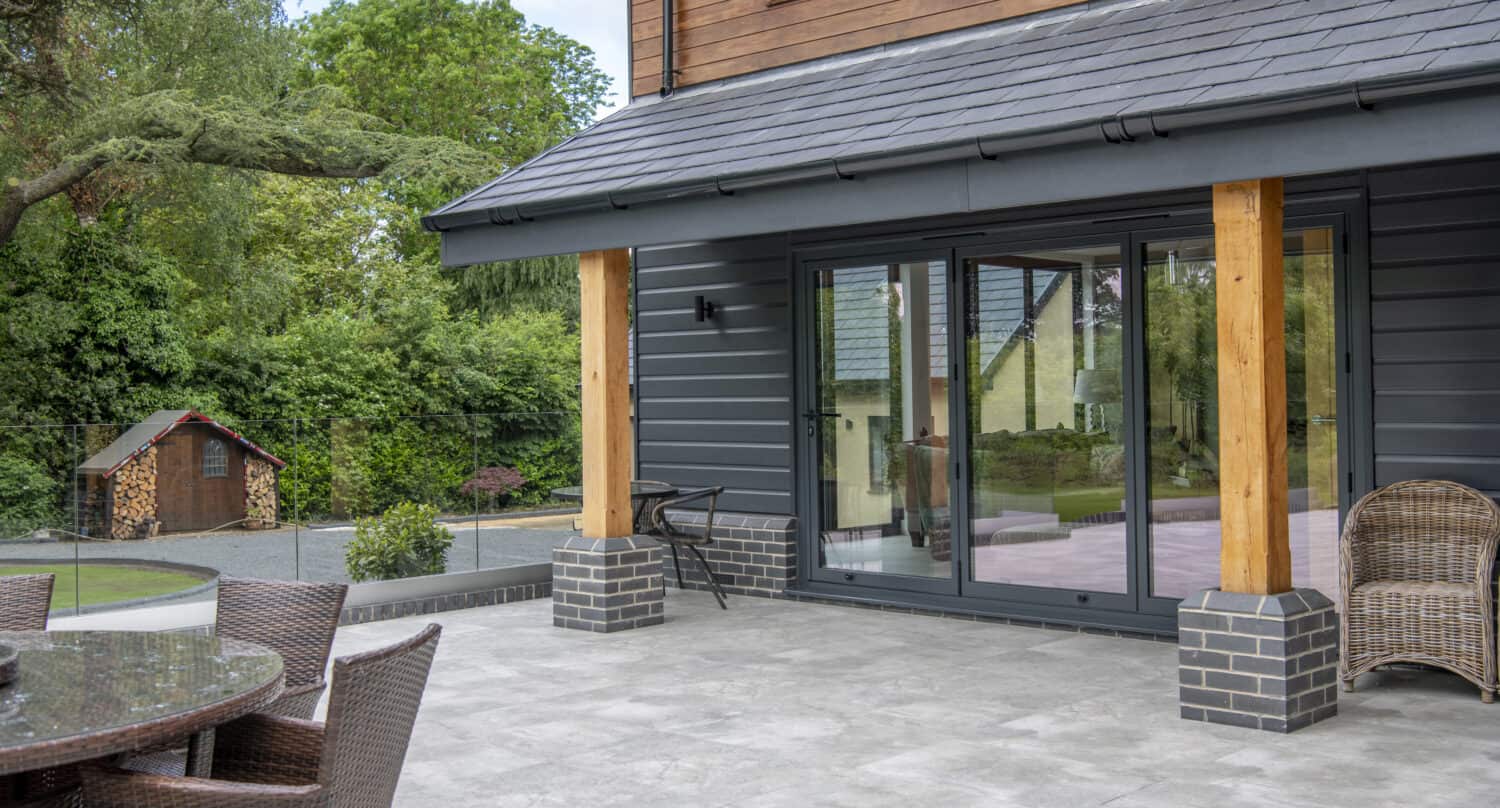 Three panel black bi folding doors to access the patio area