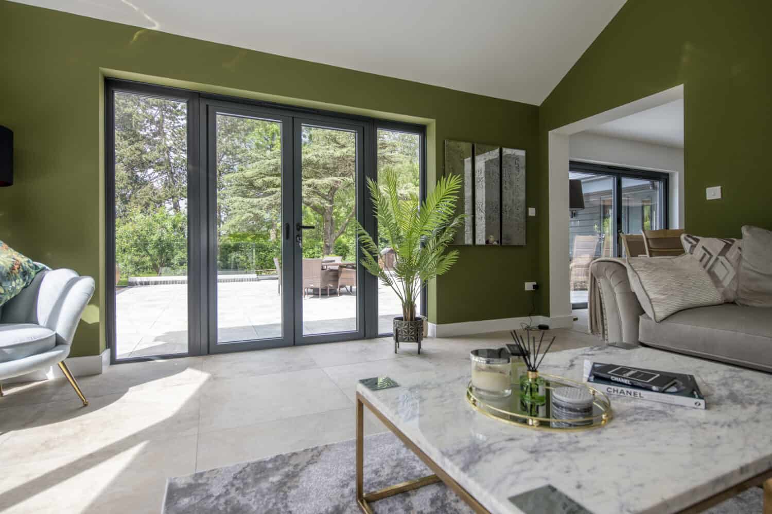 Modern living room space featuring grey aluminium french doors