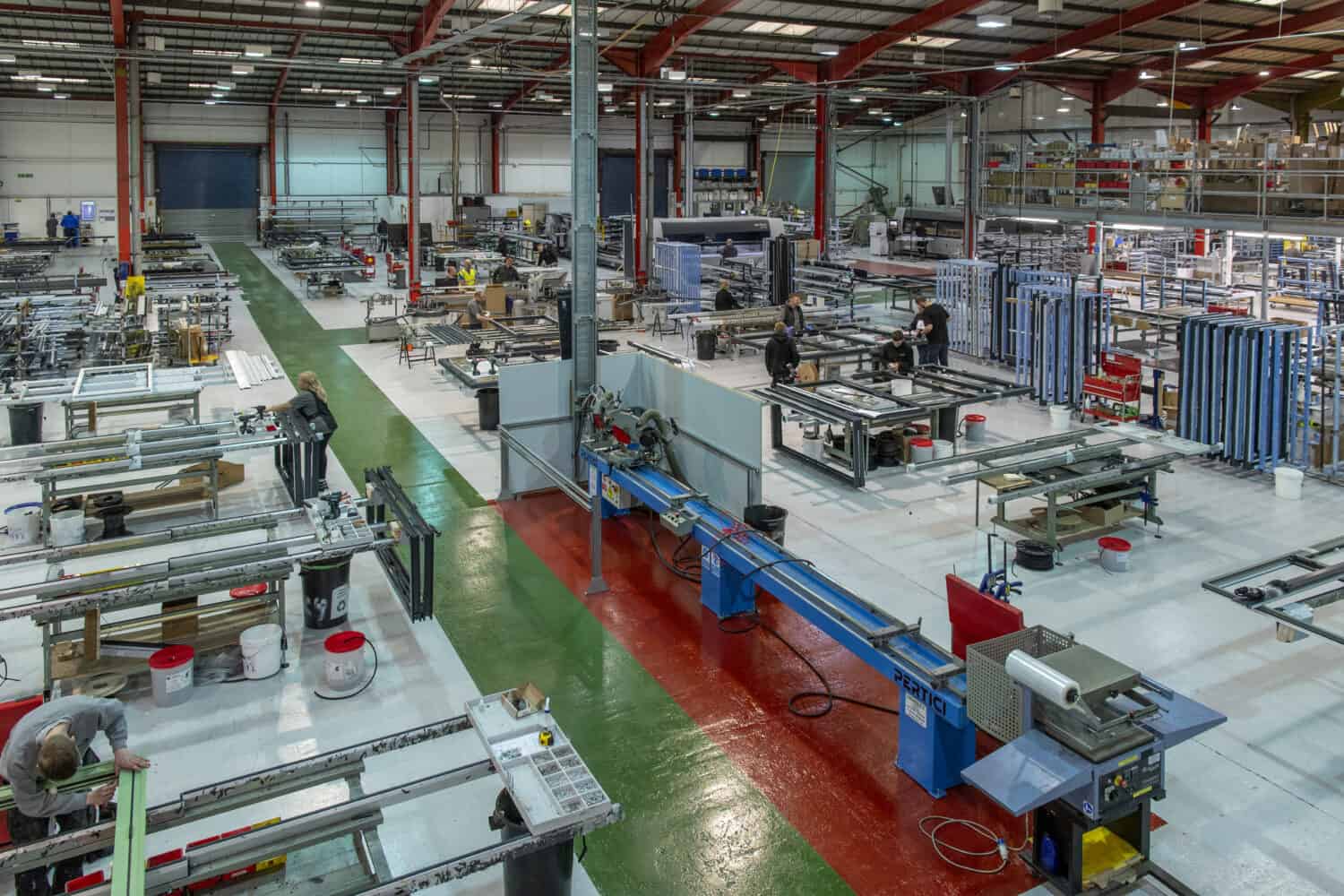 Technicians working in a bifold doors and aluminium windows manufacturing warehouse