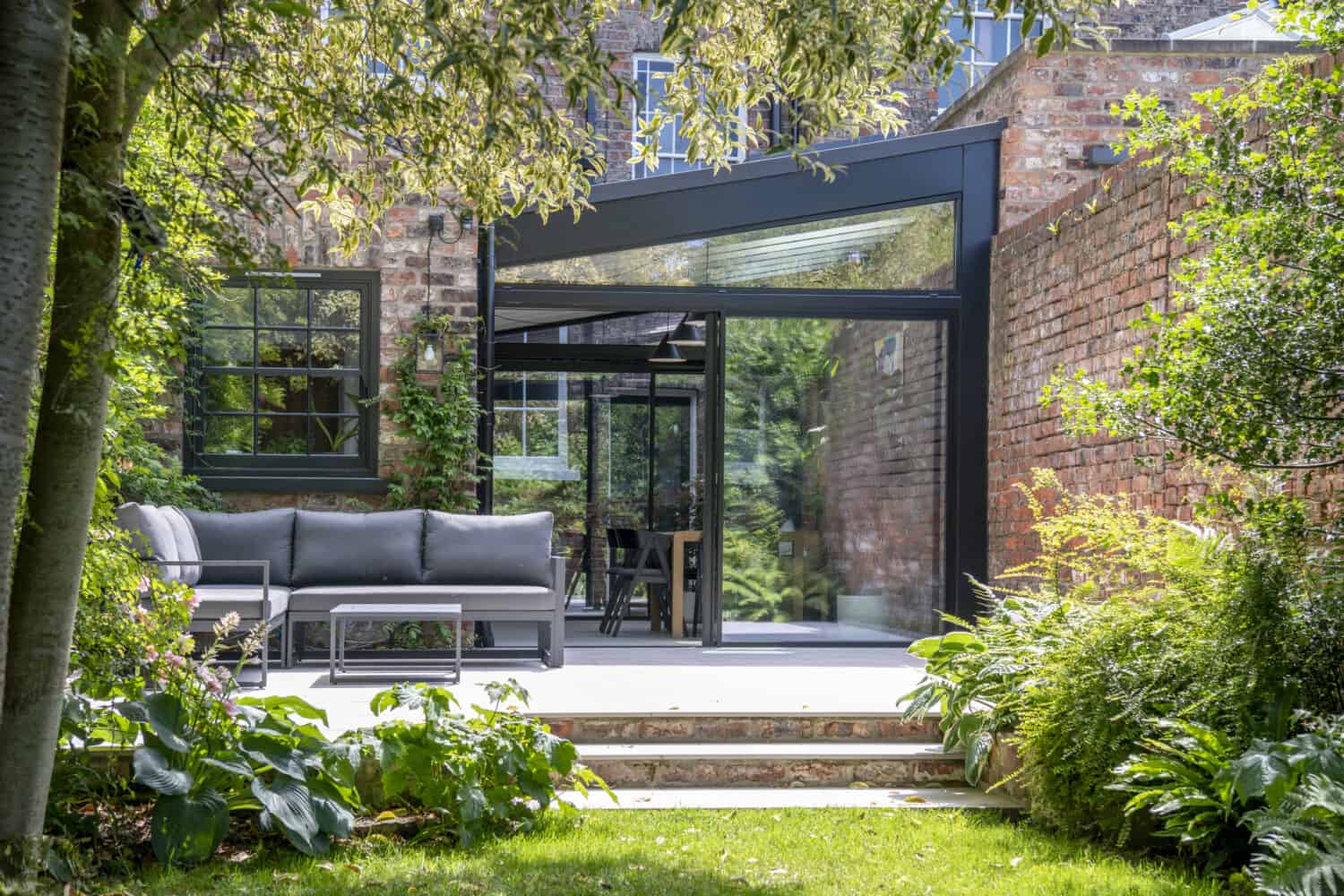 Impressive Victorian terrace house extension featuring black sliding doors
