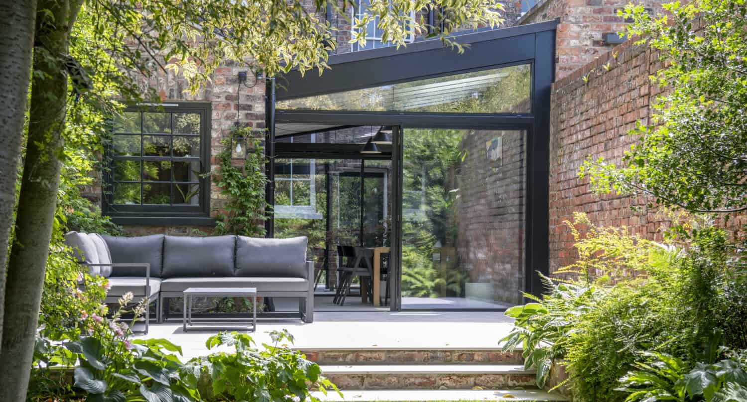 Impressive Victorian terrace house extension featuring black sliding doors