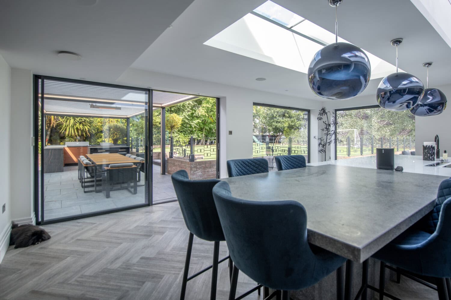 High-quality bi-folding doors opening to a spacious outdoor patio, enhancing natural light and indoor-outdoor flow in a contemporary home in Leadhall Lane, Harrogate.