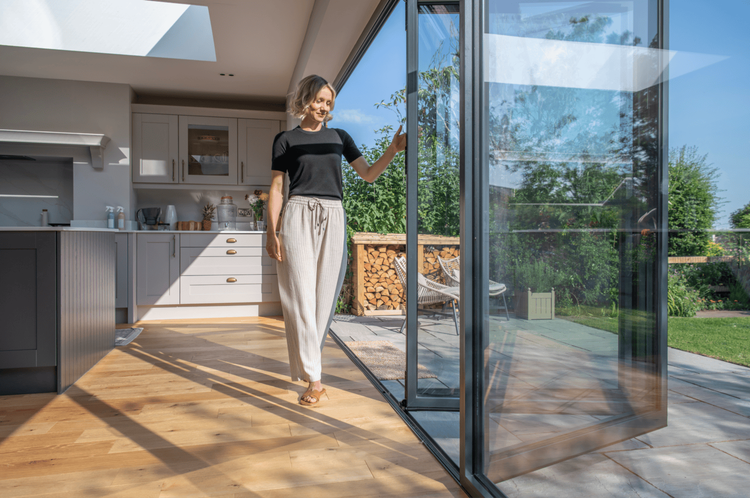 A woman standing in front of a sliding glass door.