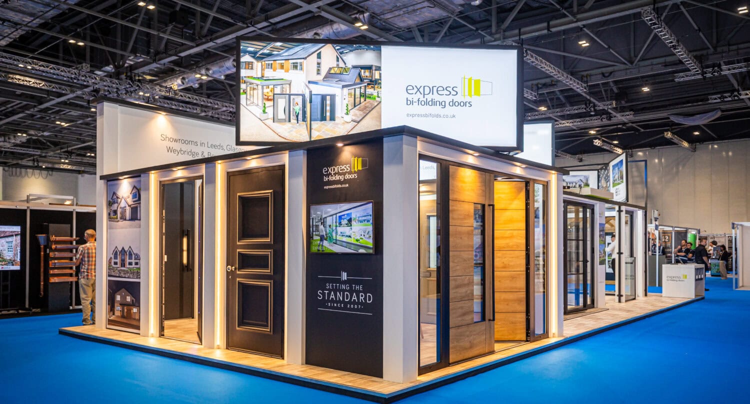 Exhibition booth showcasing modern bi-folding doors for homes and commercial spaces, highlighting their design, functionality, and quality at a trade event.