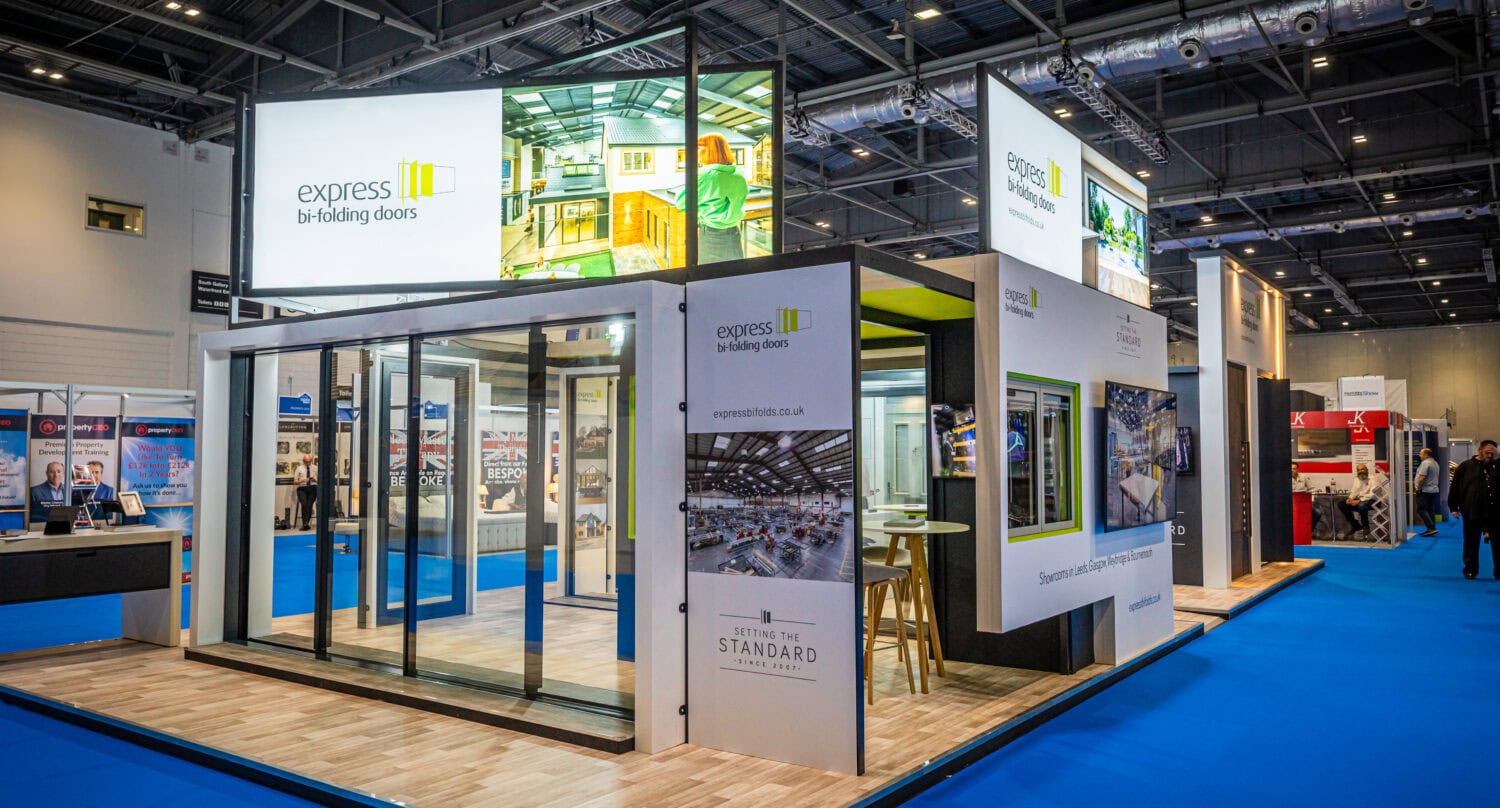Display of sleek, modern bi-folding doors by Express Bi-Folding Doors at a trade exhibition, showcasing innovative designs and high-quality materials for residential and commercial use.