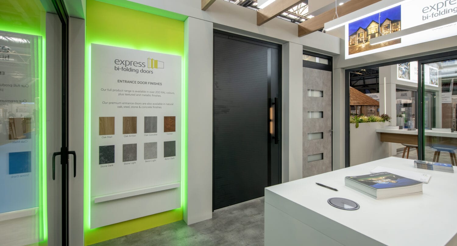 Modern display of Express Bi-Folding Doors at an exhibition, showcasing various styles and finishes for upcoming events and exhibitions.