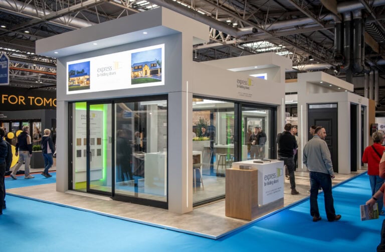 Showcasing modern bi-folding doors at a trade exhibition, highlighting their sleek design and functionality for stylish home or commercial space upgrades.