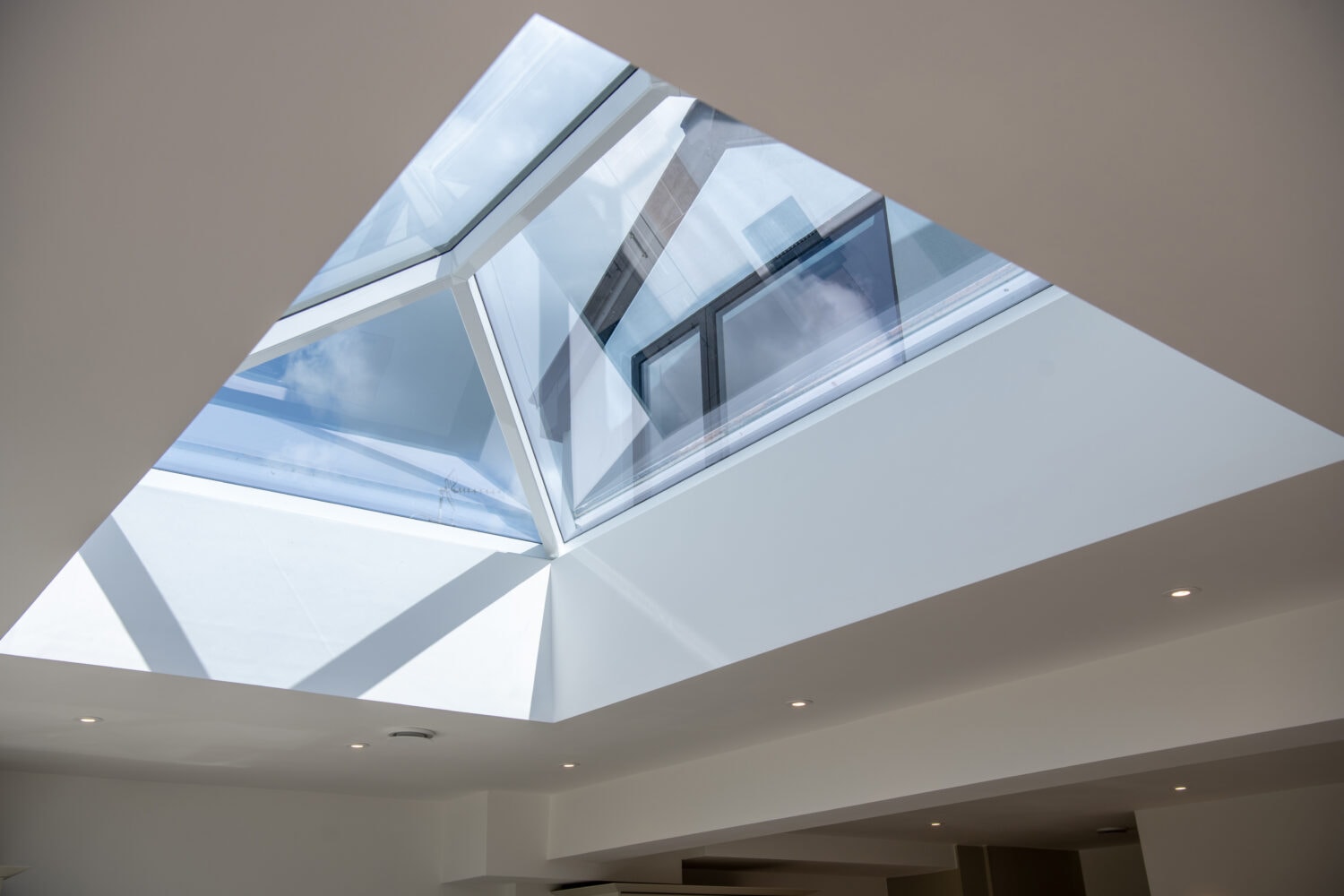 Skylight window with large glass panels, ideal for enhancing natural light in homes and commercial spaces, featuring sleek aluminium frames and a contemporary design.