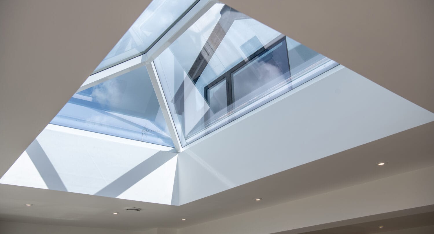 Skylight window with large glass panels, ideal for enhancing natural light in homes and commercial spaces, featuring sleek aluminium frames and a contemporary design.