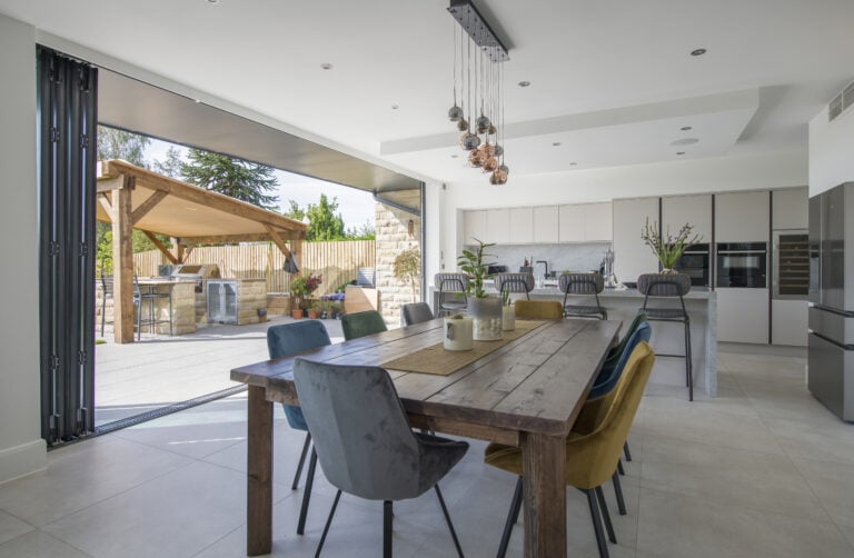 Aluminium bifold doors opening to a stylish outdoor patio, showcasing sleek external aluminium bifold doors that enhance indoor-outdoor living spaces with durability and contemporary design.