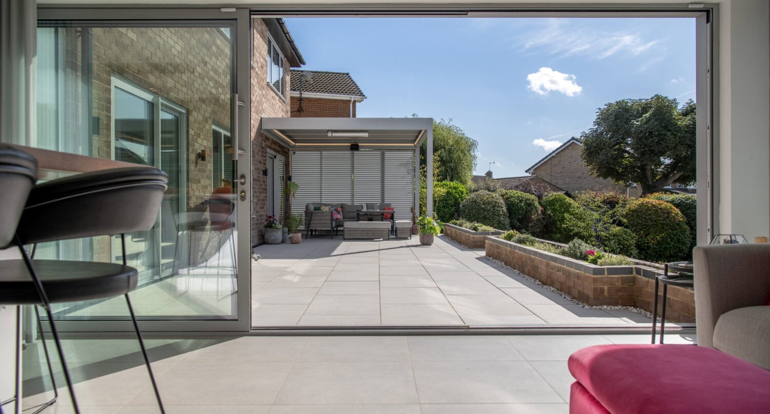 High-quality bi-folding doors opening to a spacious outdoor patio in Firs Drive, Harrogate. Enhance your home with stylish, durable, and energy-efficient folding doors.