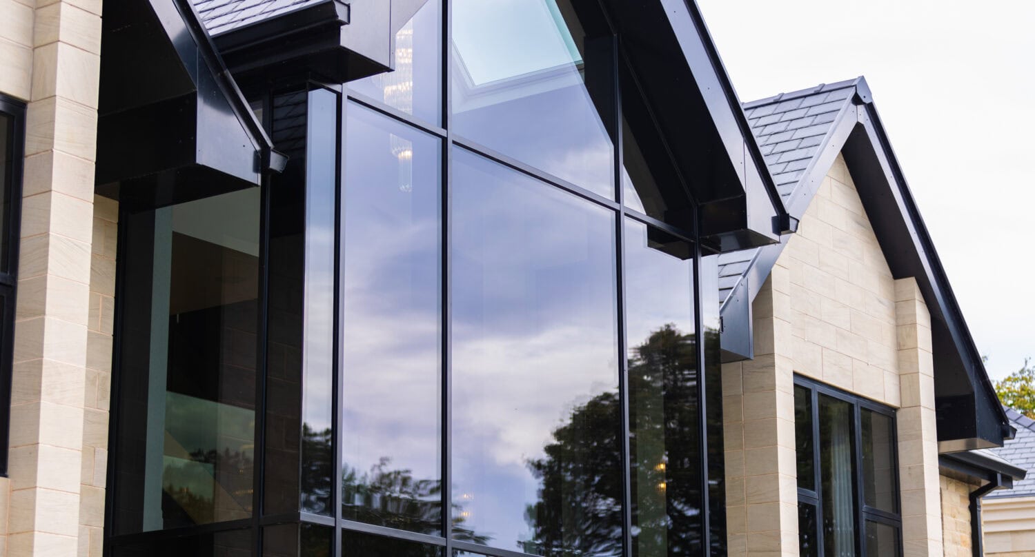 Modern glass bi-fold doors installed in a luxury residential development, offering seamless indoor-outdoor living and panoramic views.