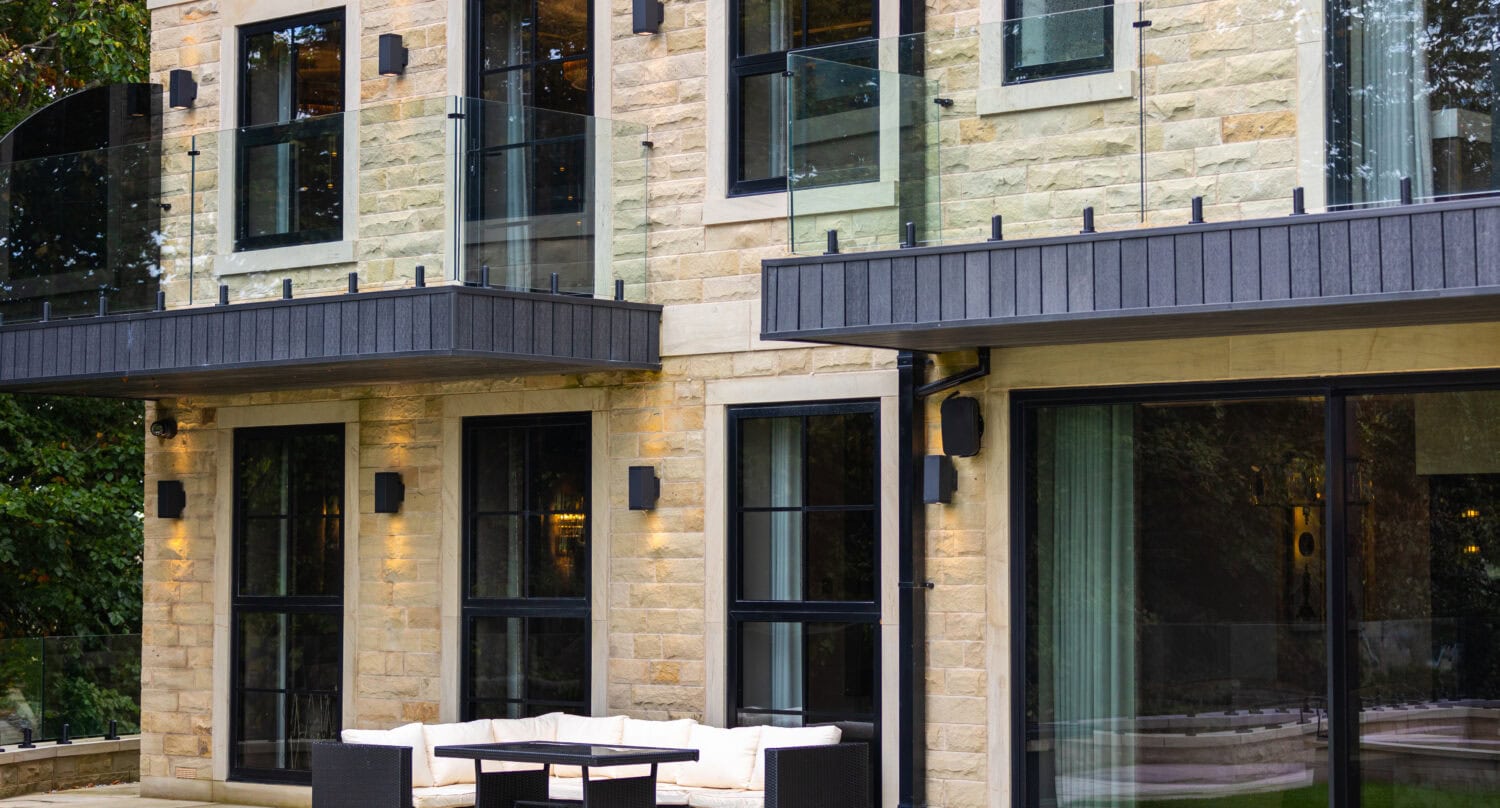 Elegant bi-folding doors opening to outdoor patio at Arlington Luxury Development, showcasing modern design and seamless indoor-outdoor living.