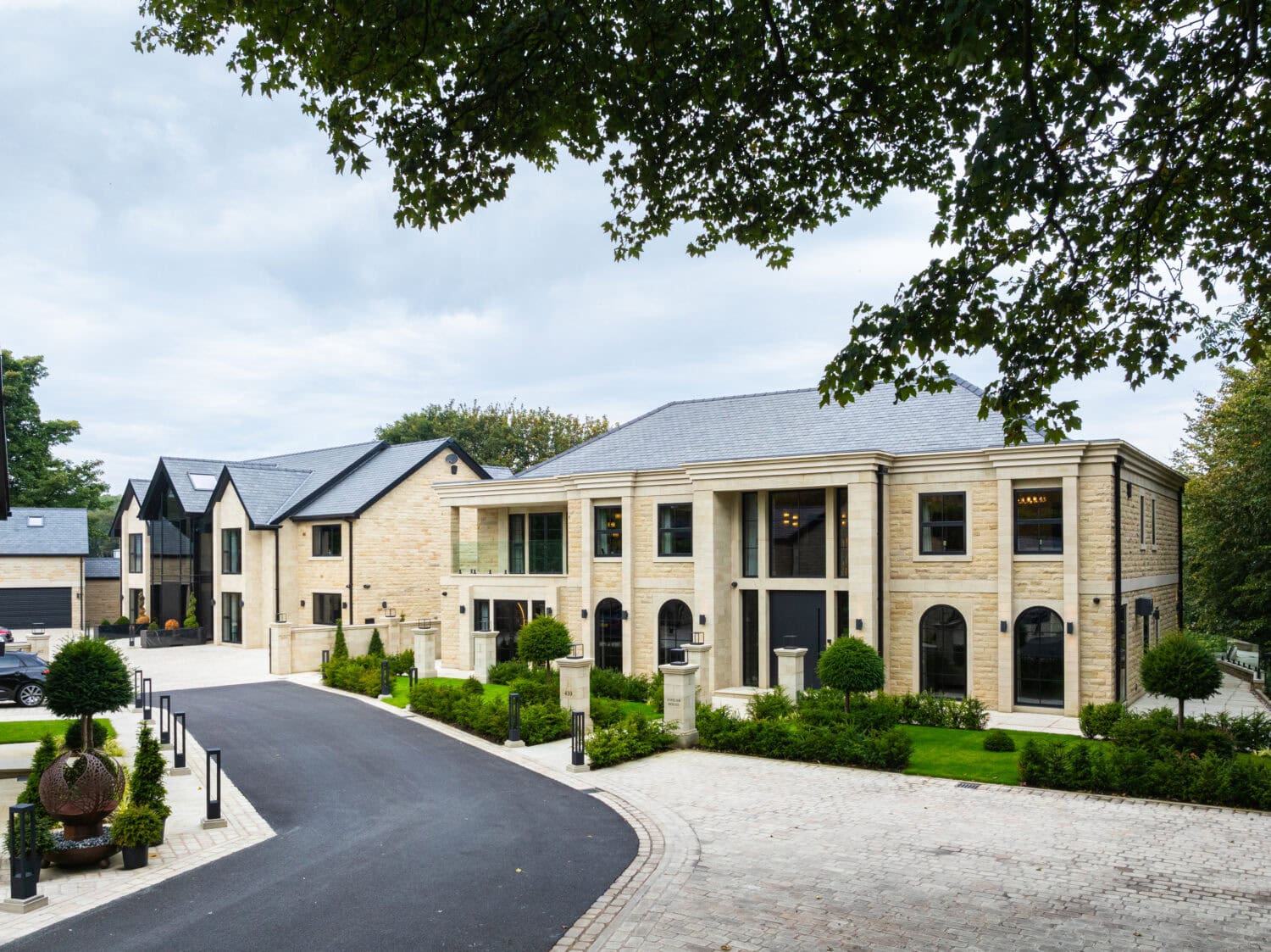 Modern residential building featuring stylish pivot doors, enhancing curb appeal and functionality with sleek design and durable materials.