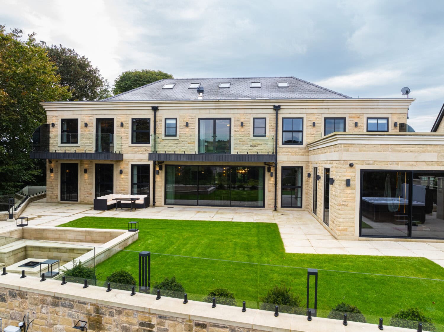 Elegant bi-folding doors opening to a landscaped garden in a luxury Arlington development. Perfect for modern living and seamless indoor-outdoor flow.