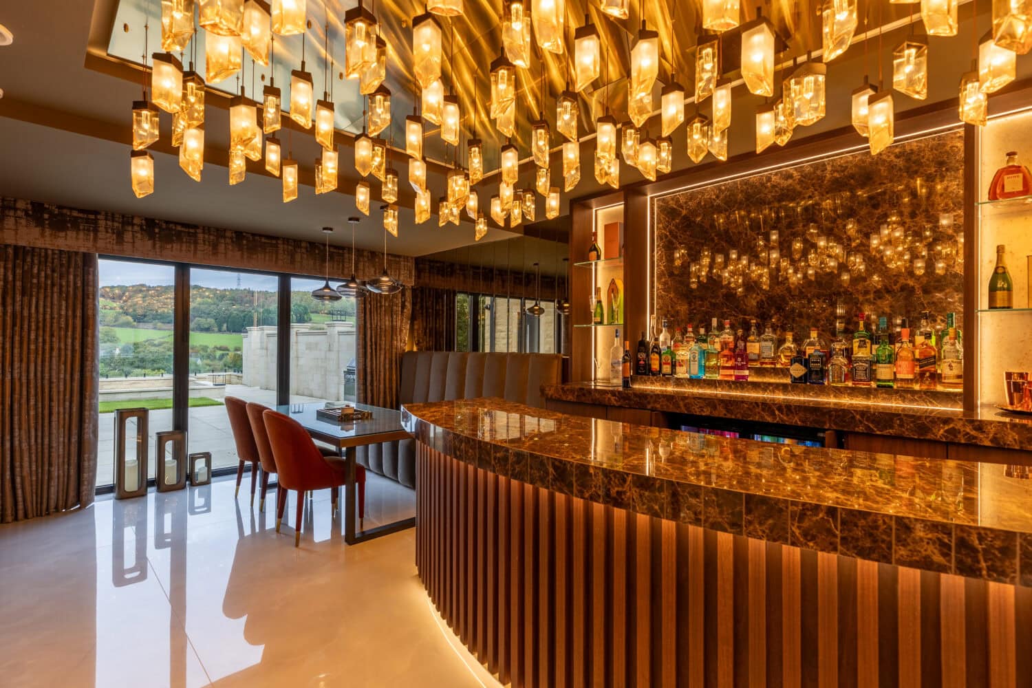 Modern living space featuring large bi-folding doors opening to scenic outdoor views, perfect for seamless indoor-outdoor living in the Arlington luxury development.