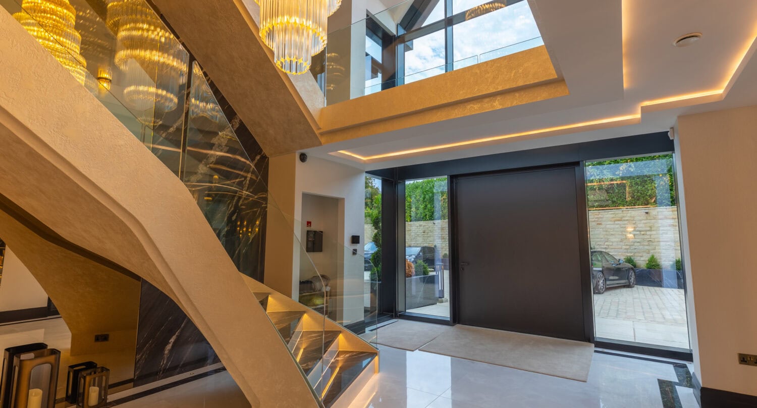 Modern interior featuring large bi-fold doors opening to outdoor space, enhancing natural light and seamless indoor-outdoor living at Arlington Luxury Development.