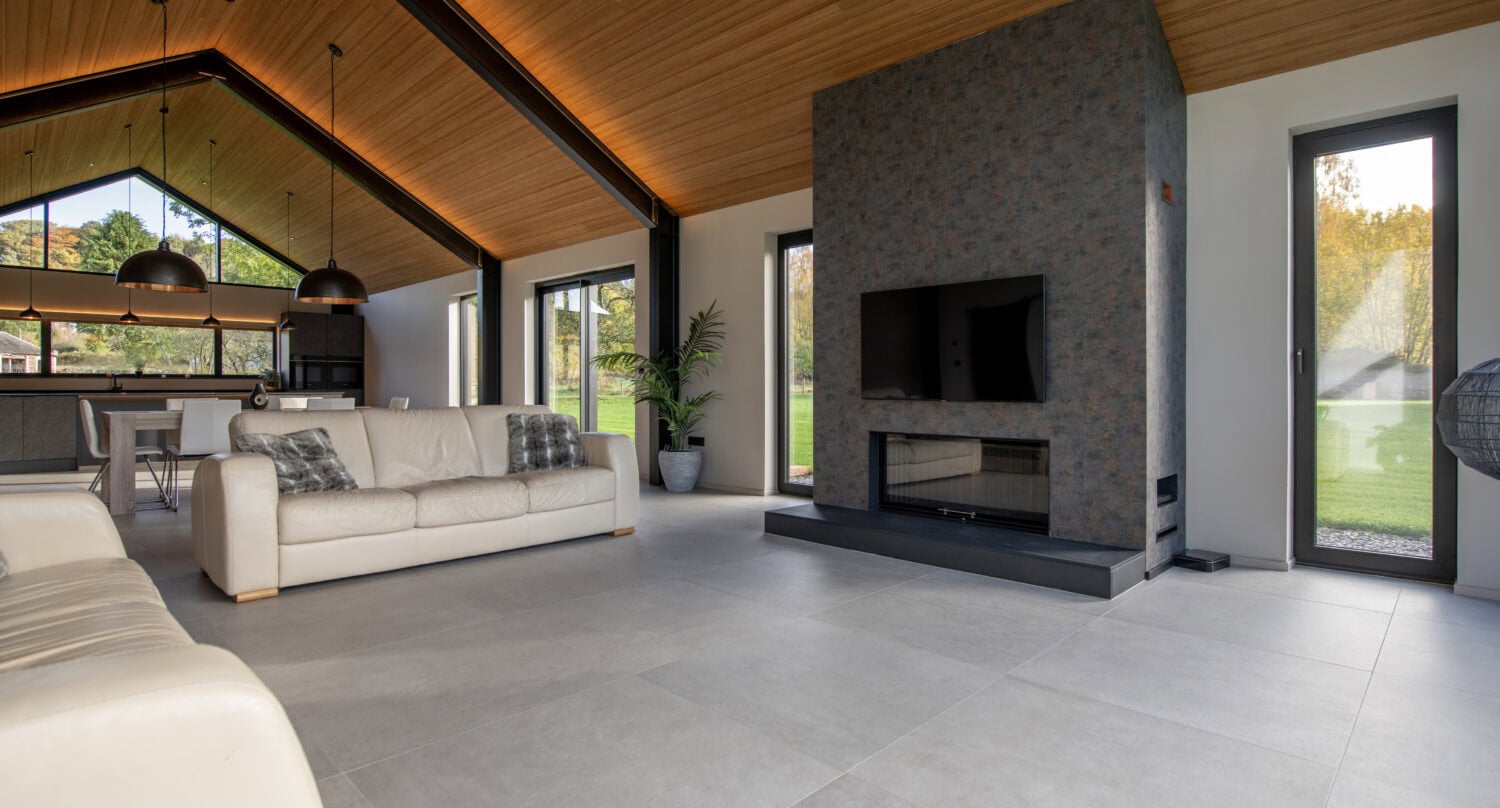 Bright, spacious living room featuring large bi-fold doors opening to outdoor views at Orchard Farm, Crossford, showcasing stylish design and natural light.