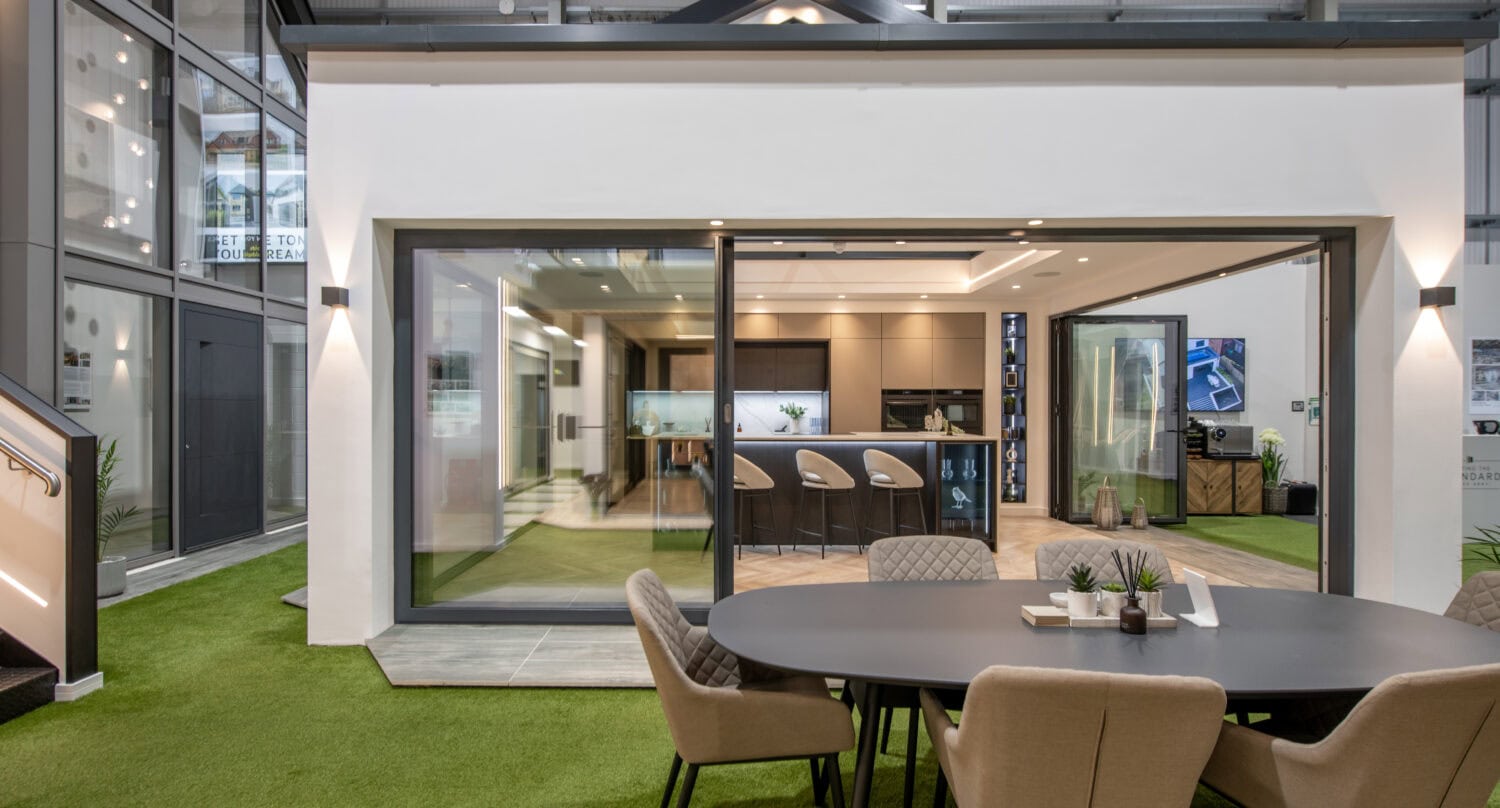 Bi-folding doors opening to a stylish indoor-outdoor living space in Glasgow. Perfect for enhancing natural light and creating seamless transitions between indoors and outdoors.