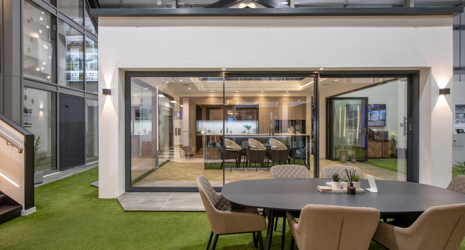 Bi-folding doors in a modern Glasgow showroom, showcasing sleek, space-saving designs that enhance indoor-outdoor living. Perfect for homes seeking stylish, functional access solutions.