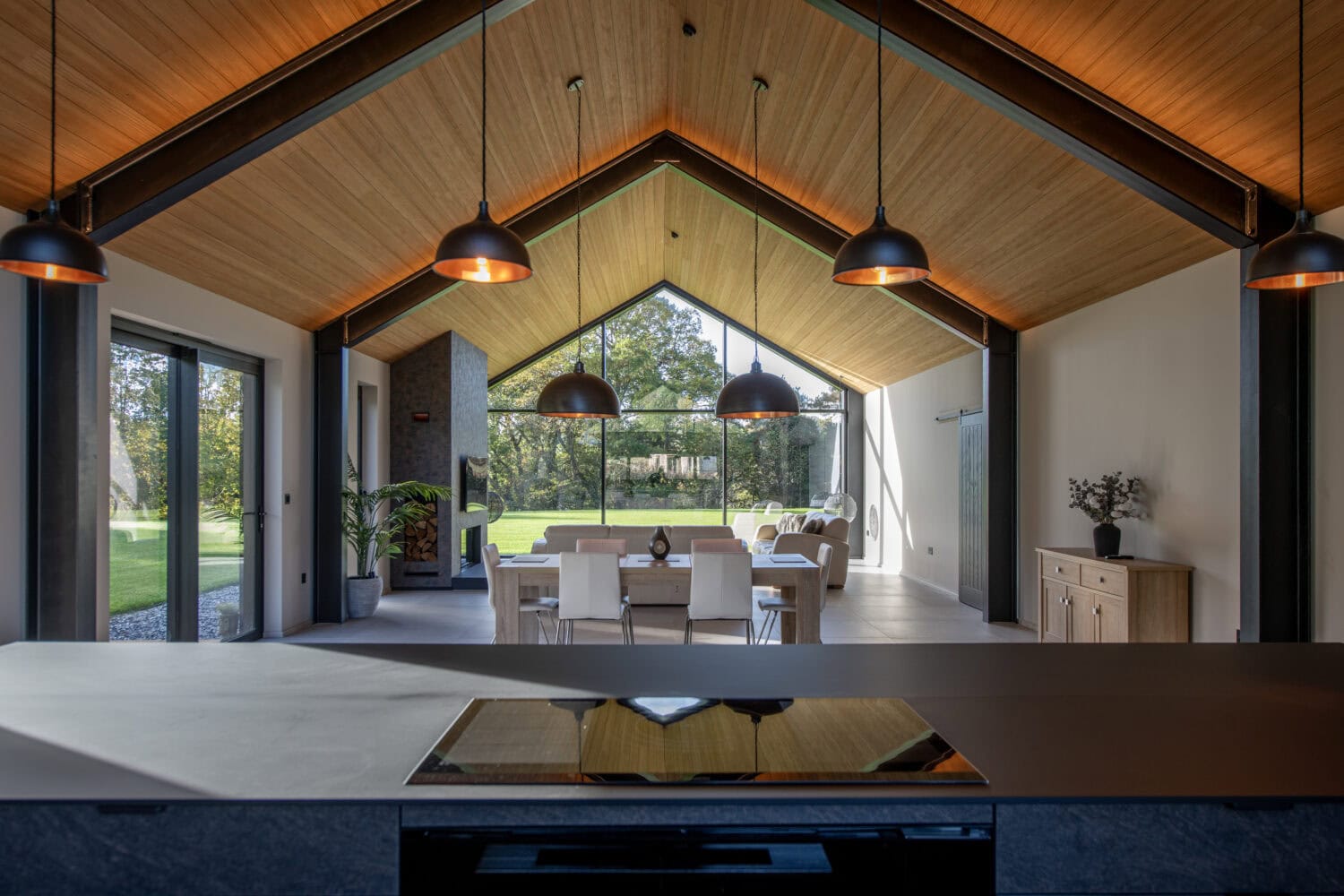 Elegant bi-folding doors opening to a bright, spacious living area at Orchard Farm, Crossford, showcasing seamless indoor-outdoor transition and contemporary design.