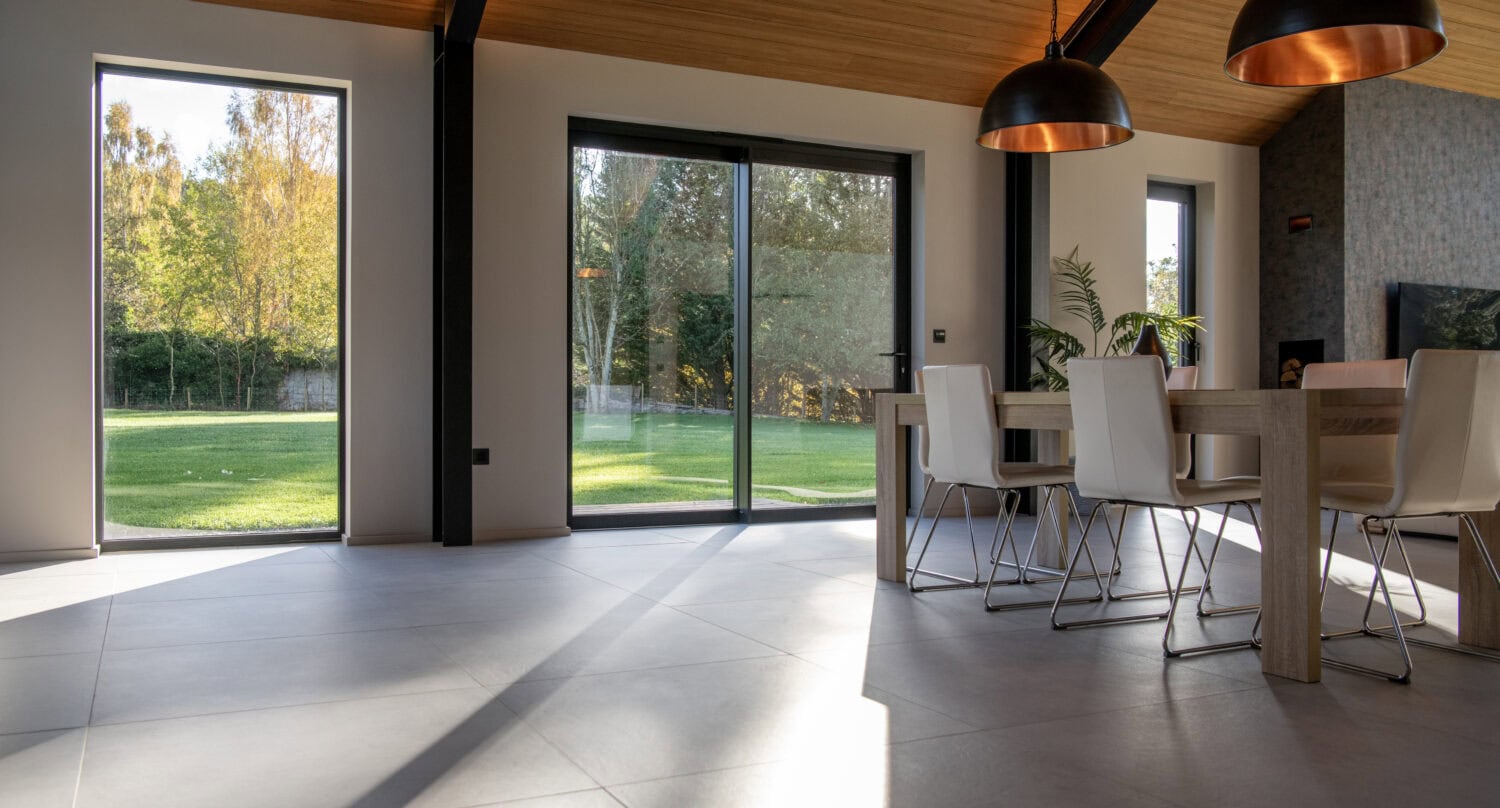 Elegant bi-folding doors from Express Bi-Folds, ideal for Orchard Farm, Crossford, offering stylish, space-saving solutions that enhance natural light and outdoor views.