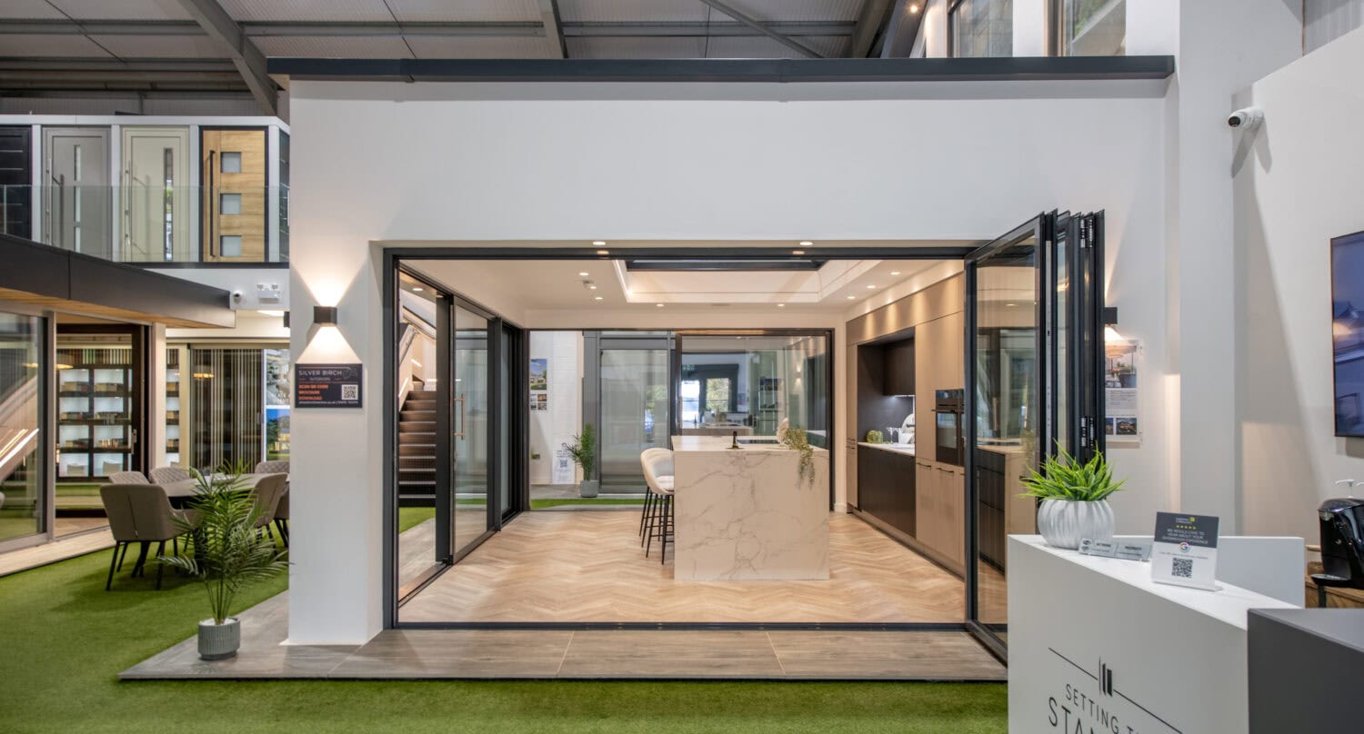 Modern bi-folding doors displayed in Glasgow showroom, highlighting sleek design and seamless indoor-outdoor transition for stylish home improvements.