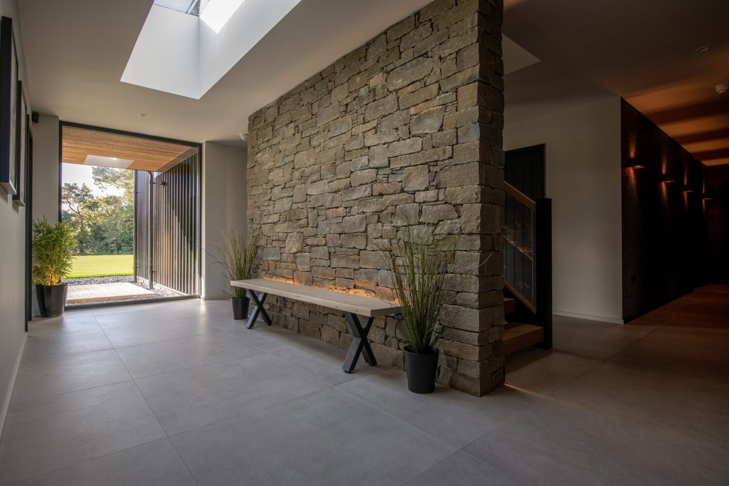 Elegant bi-folding doors opening to outdoor garden at Orchard Farm, Crossford, showcasing seamless indoor-outdoor living.