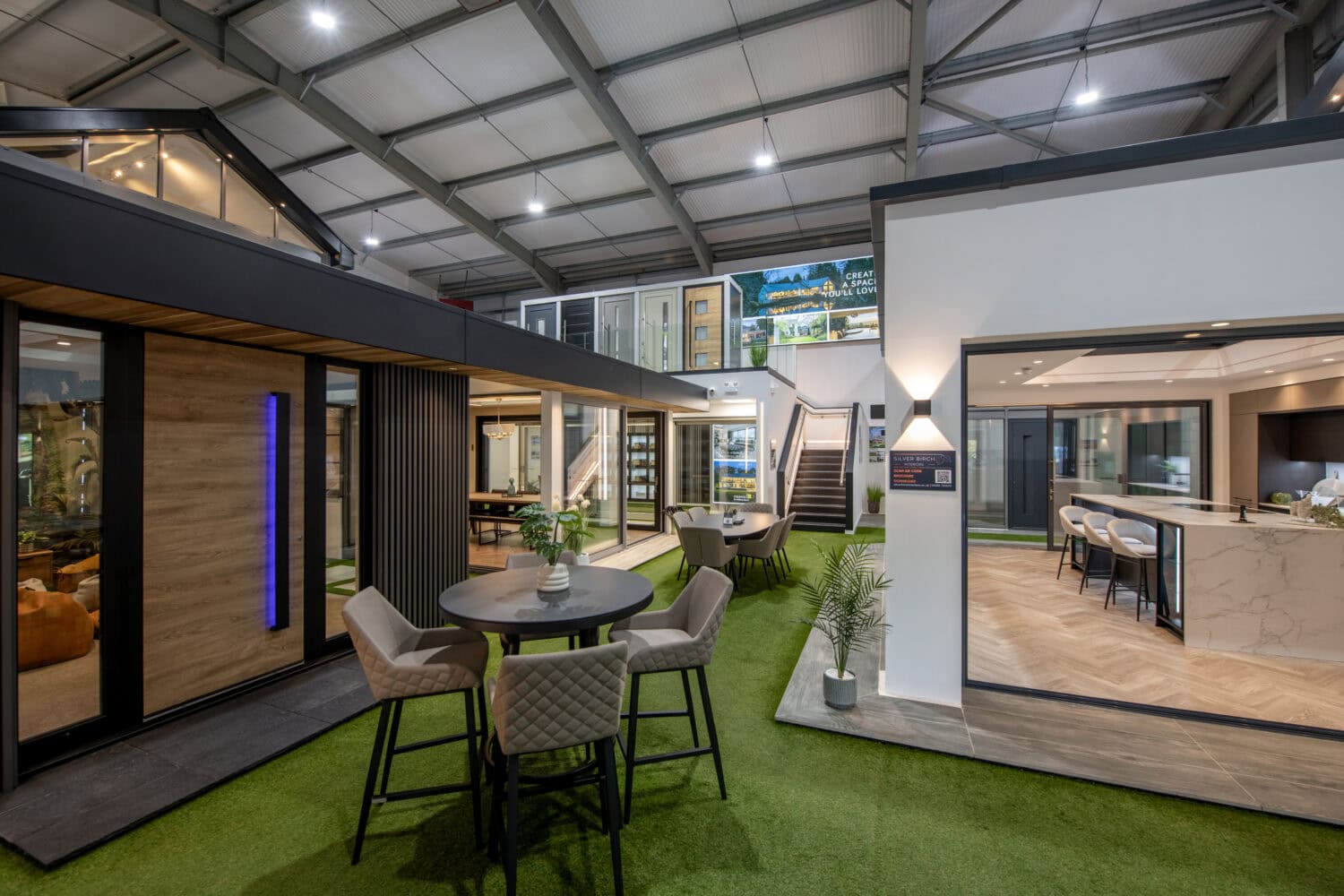 Bi-folding doors in a Glasgow showroom, showcasing sleek, high-quality aluminium frames that open up living spaces to outdoor areas, perfect for contemporary home designs.