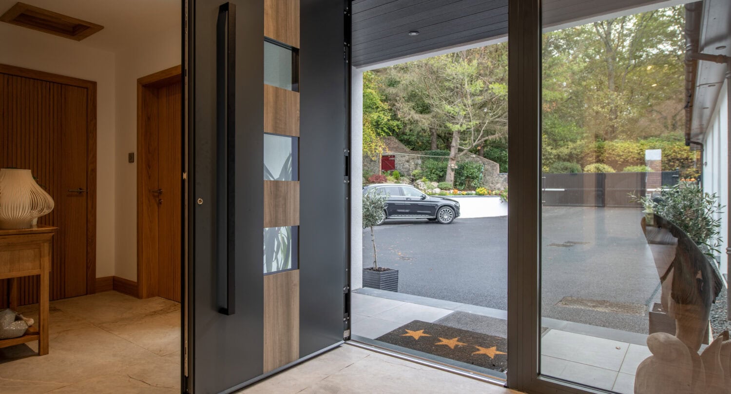 Elegant bi-folding doors opening to the garden, providing seamless indoor-outdoor living space. High-quality aluminium frames with large glass panels enhance natural light and style.