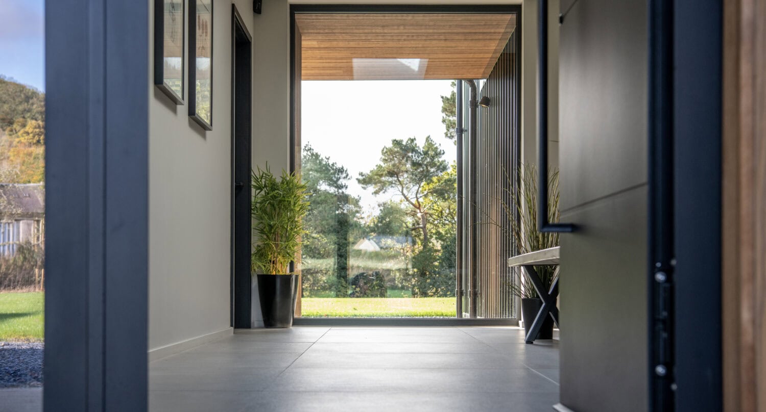 High-quality bi-folding doors at Orchard Farm, Crossford, offering seamless indoor-outdoor living with durable aluminium frames and large glass panels.