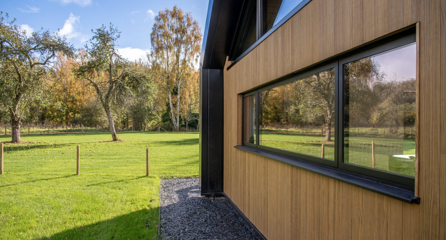 High-quality bi-folding doors at Orchard Farm, Crossford, offering seamless indoor-outdoor living with durable aluminium frames and large glass panels.