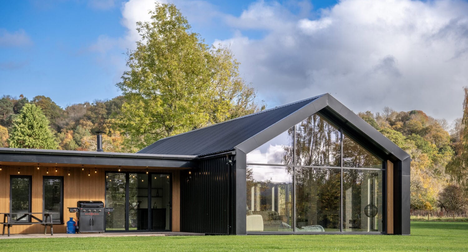 High-quality black bi-folding doors at Orchard Farm, Crossford, offering expansive views and easy access to outdoor space, enhancing natural light and aesthetic appeal.