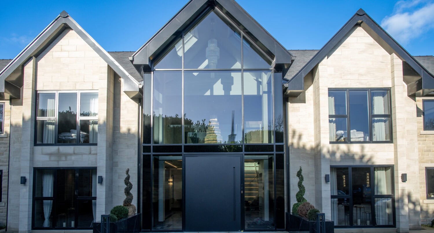 Elegant bi-folding doors with large glass panels, perfect for connecting indoor and outdoor living spaces in contemporary homes.