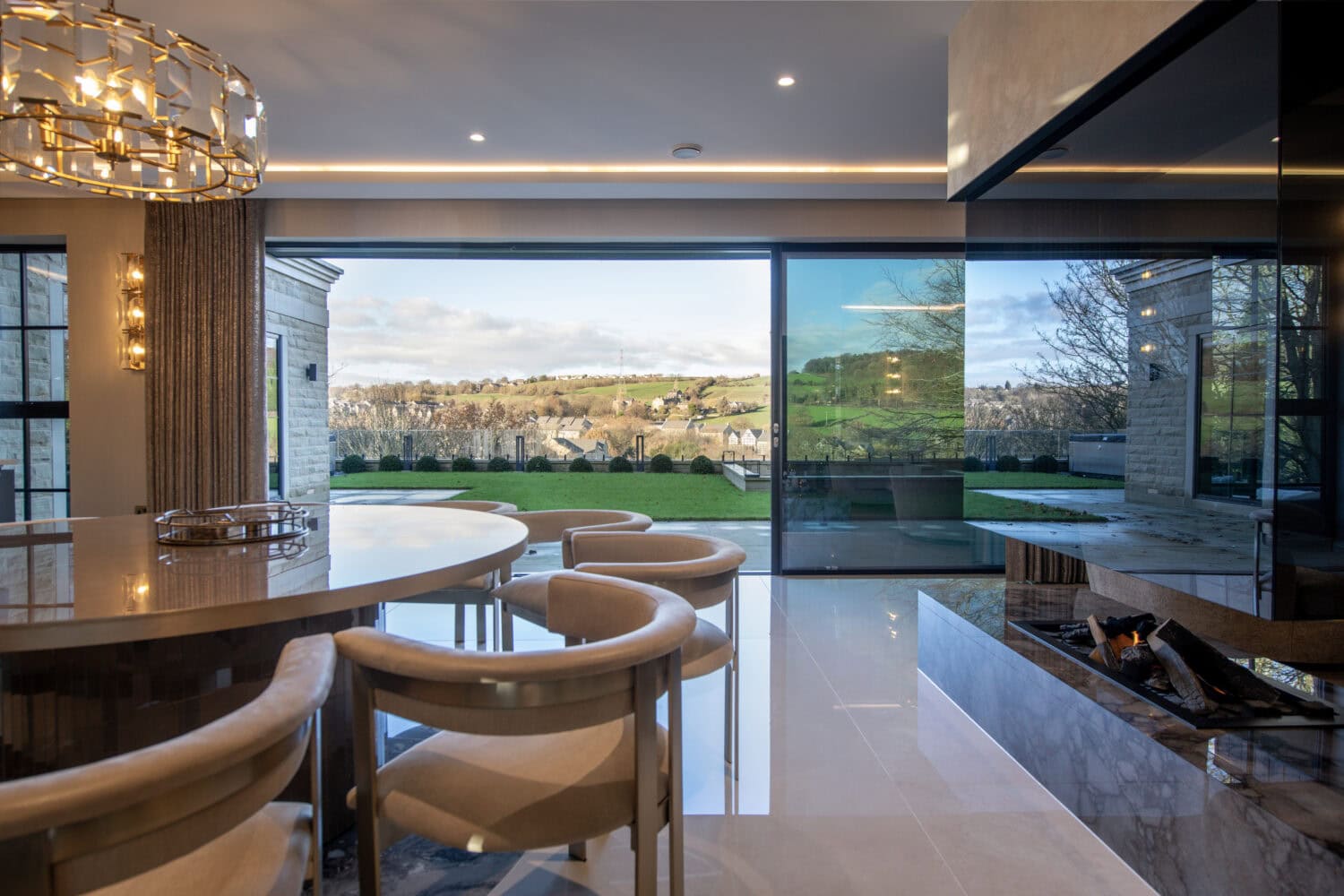 High-quality XP Glide bi-fold doors opening to scenic outdoor views.