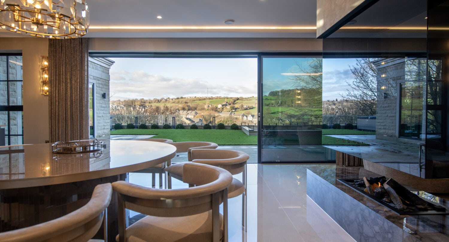 High-quality XP Glide bi-fold doors opening to scenic outdoor views.