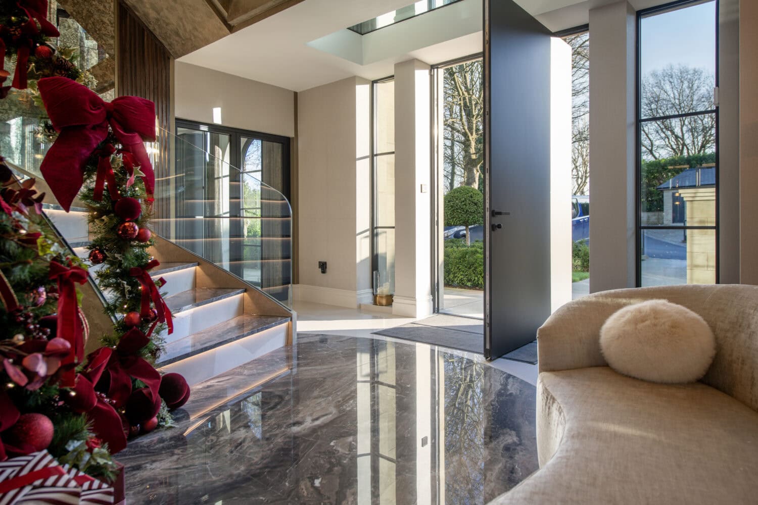 Elegant pivot doors opening to a bright, modern interior with large glass panels and sleek design, ideal for enhancing home aesthetics and natural light.