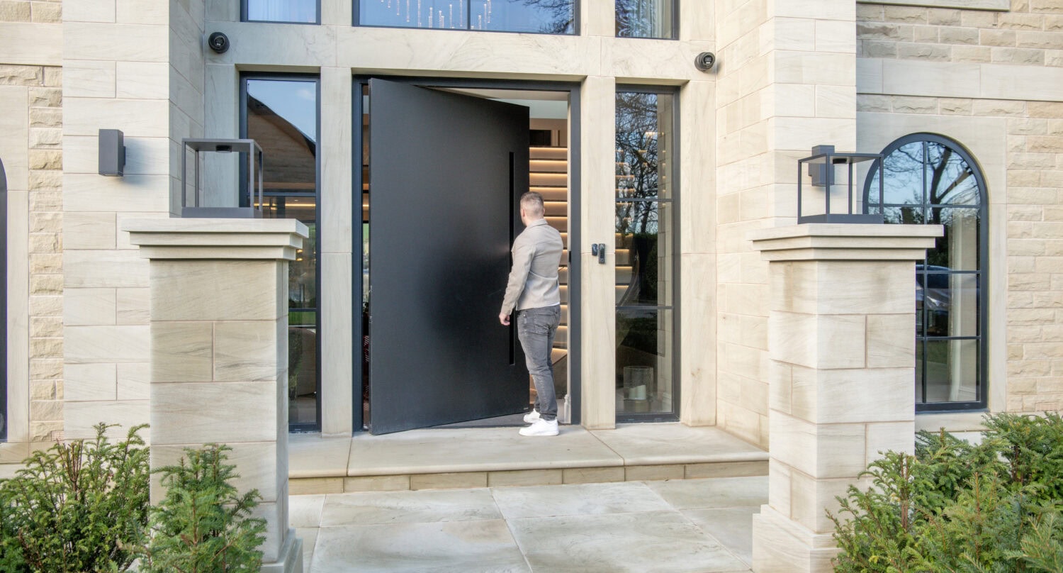 Elegant pivot doors installed at a contemporary home entrance, showcasing sleek design and high-quality materials for enhanced curb appeal and security.