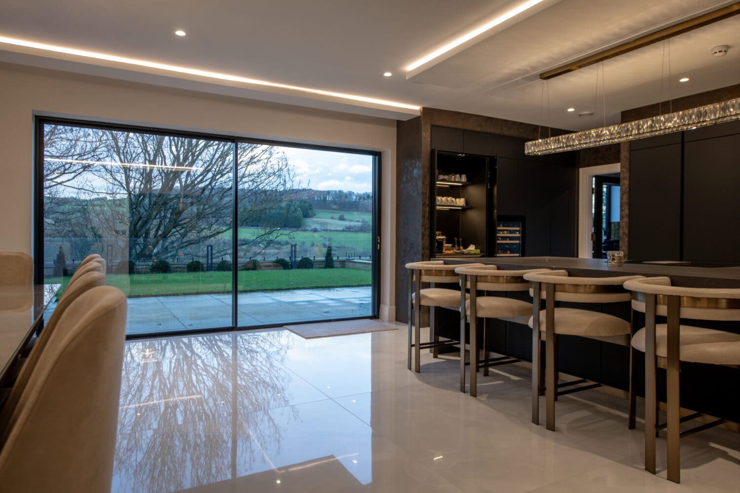 High-quality XP Glide bi-fold doors opening to a scenic outdoor view.