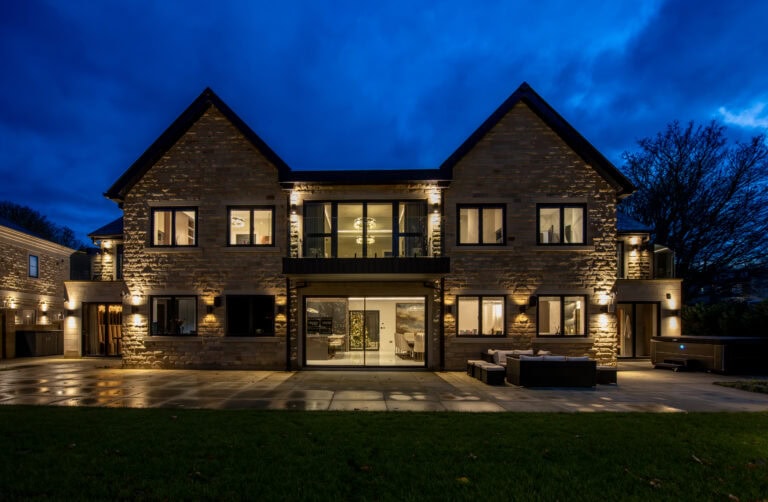 High-quality bi-folding doors opening to a modern home exterior.
