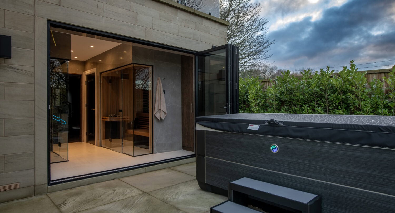 Stylish steel-look bi-fold doors opening to outdoor space, enhancing modern home aesthetics and functionality. Perfect for seamless indoor-outdoor living with durable, sleek design.