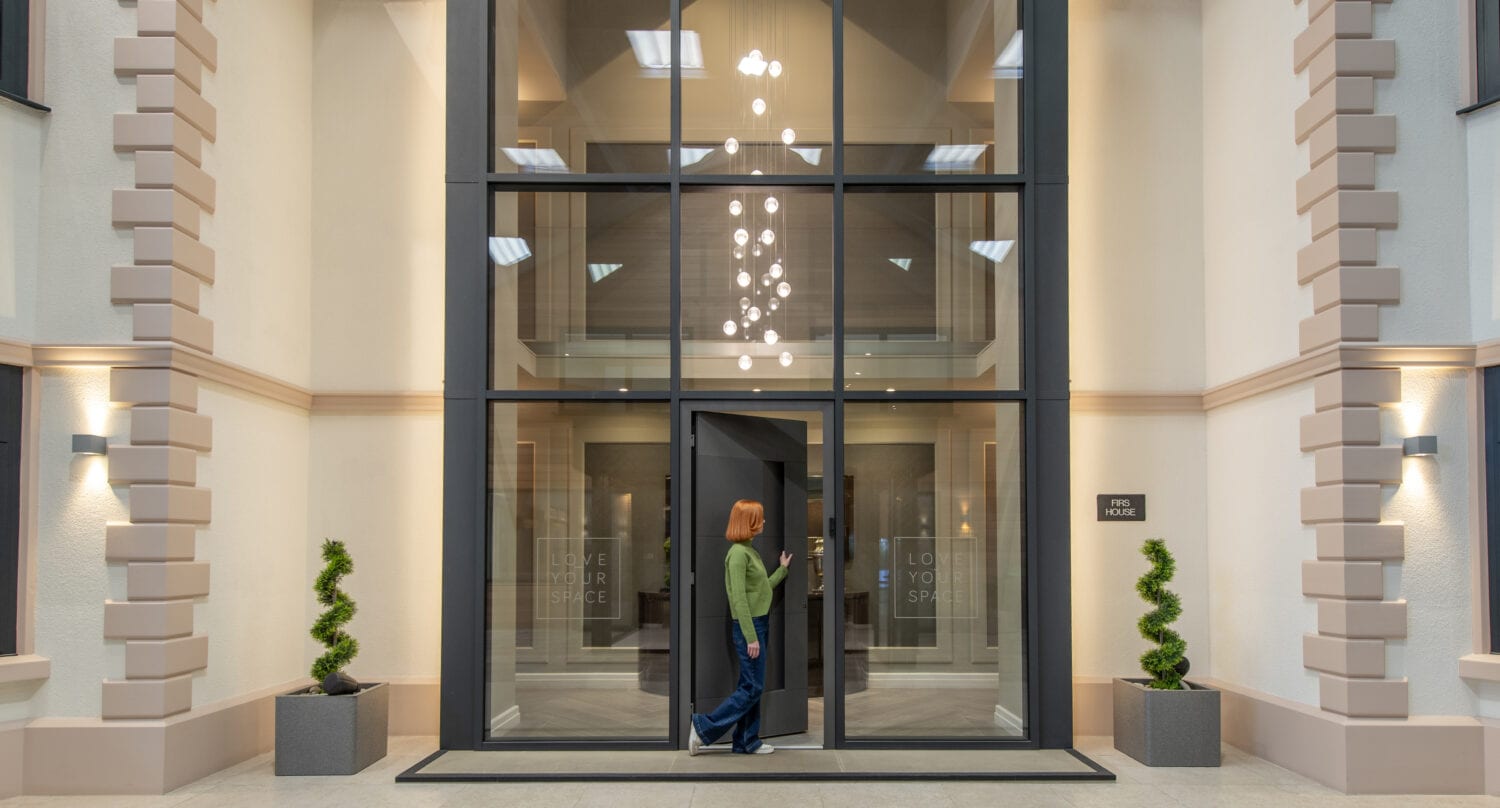 Modern glass bi-folding doors at the new Milton Keynes showroom opening on March 16th, showcasing stylish and energy-efficient entrance solutions.