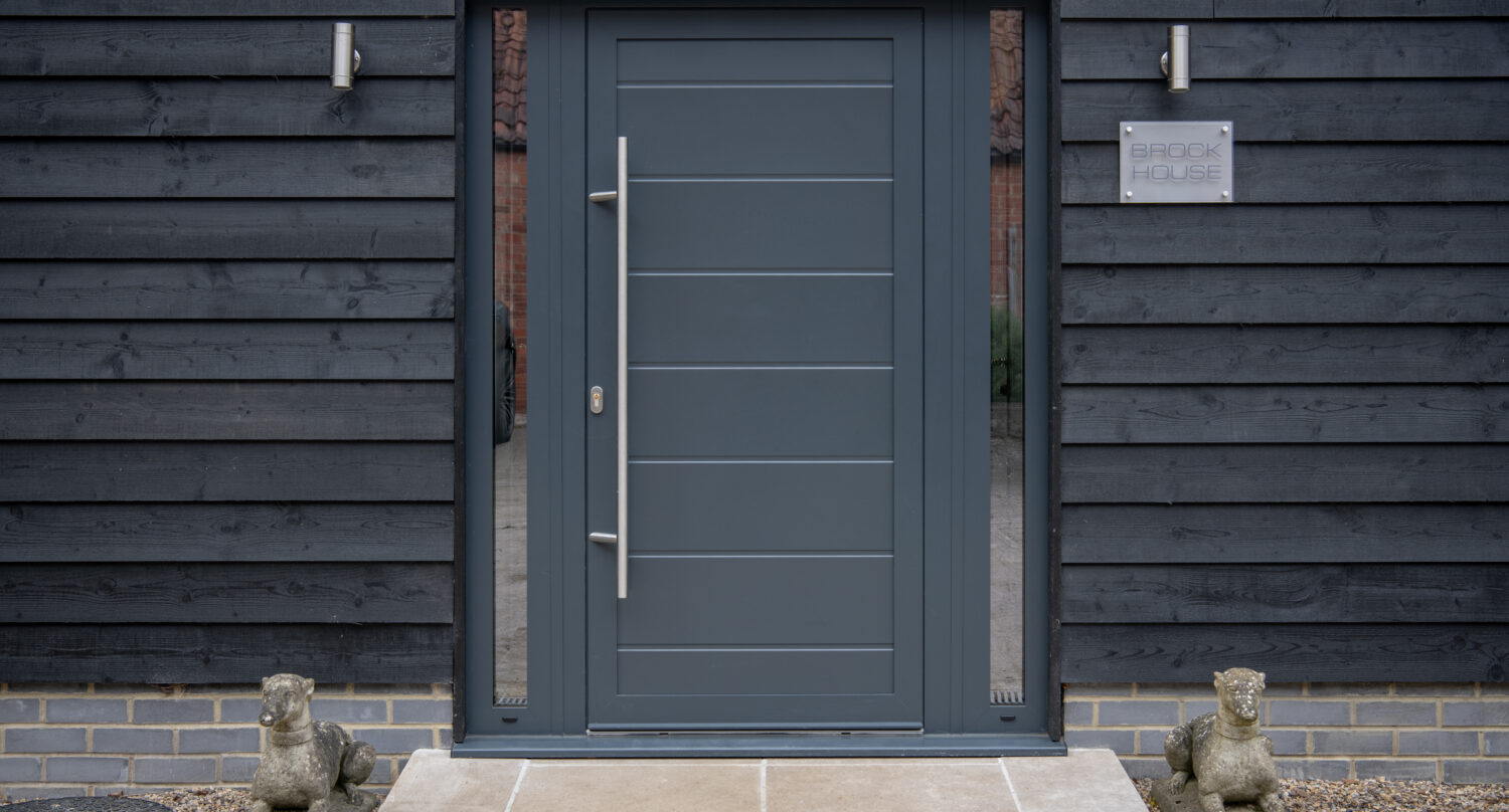 Stylish XP77 entrance door featuring bi-folding glass panels, ideal for enhancing home security and aesthetic appeal. Perfect for contemporary residential entrances.