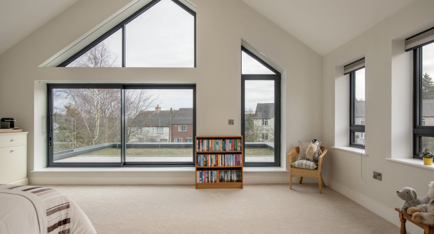 Elegant black-framed bi-folding doors opening to a spacious balcony, enhancing natural light and outdoor views in the Chapel Grove home. Perfect for seamless indoor-outdoor living.
