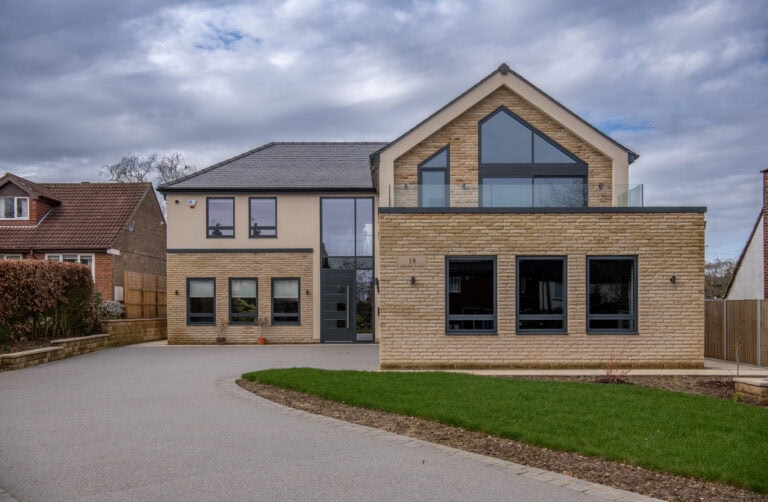 Elegant bi-folding doors opening to the garden at Chapel Grove residence, showcasing contemporary design and seamless indoor-outdoor living.