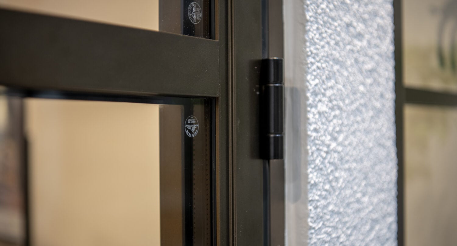 High-quality black aluminium bi-folding doors installed in a Leeds showroom, showcasing sleek design and durability for modern homes and commercial spaces.