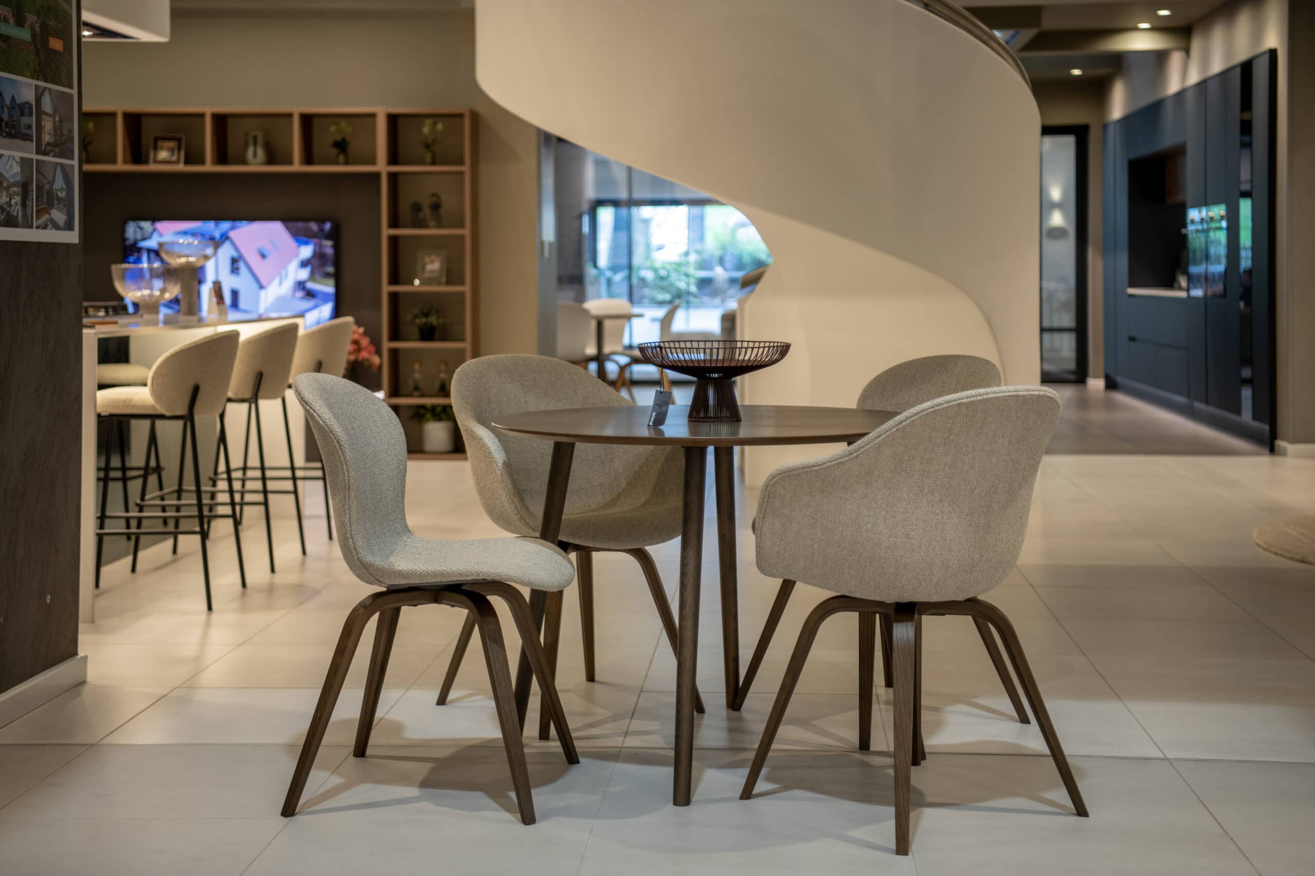 Contemporary Leeds showroom featuring stylish furniture and a sleek spiral staircase, showcasing the latest in modern interior design for 2026.