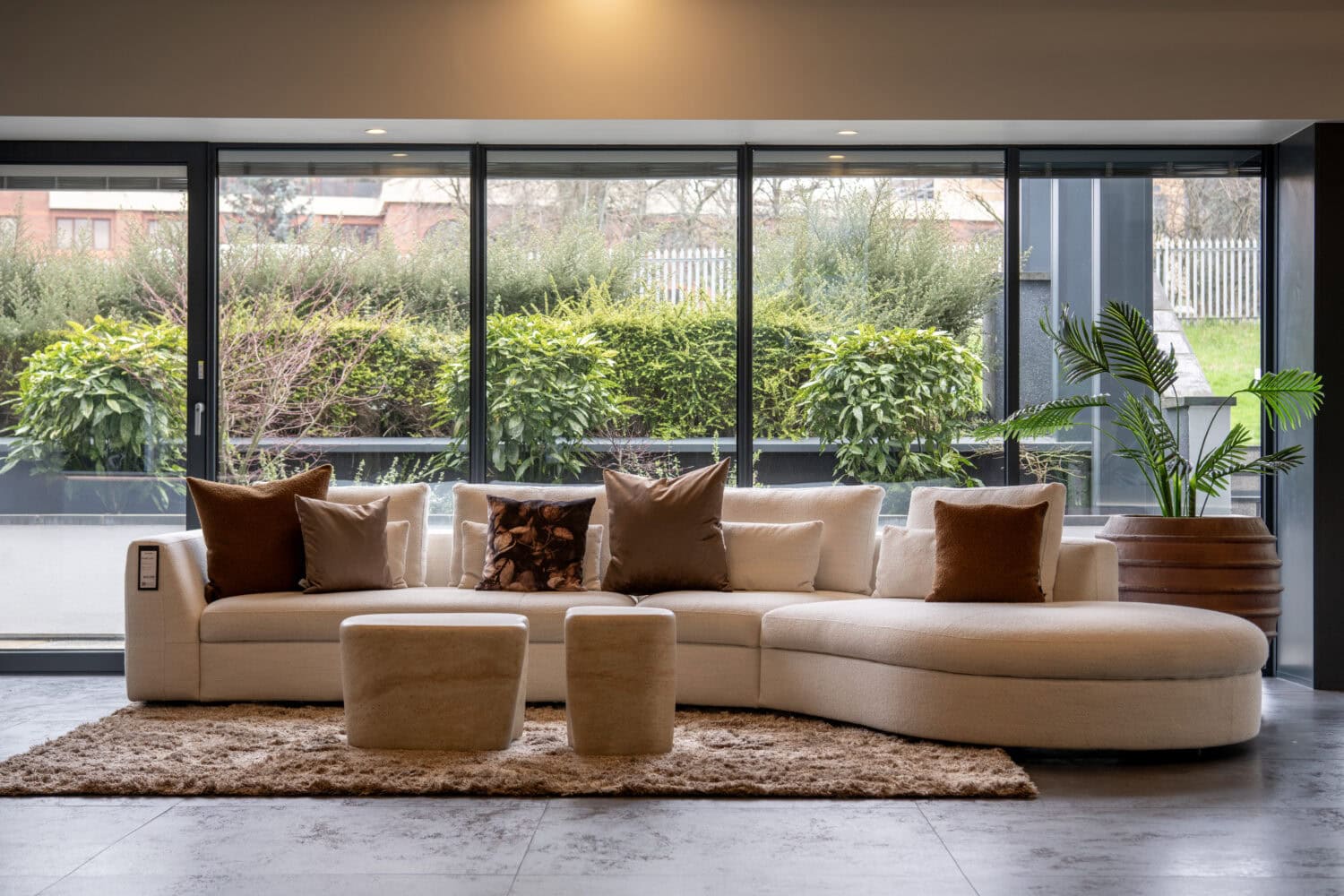 Elegant Leeds showroom featuring large bi-folding doors opening to a lush garden, showcasing modern home design and the seamless integration of indoor and outdoor living spaces.