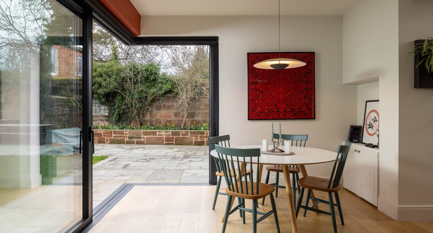 Elegant bi-fold doors opening to outdoor patio in Main Street, Uddingston, showcasing seamless indoor-outdoor living.