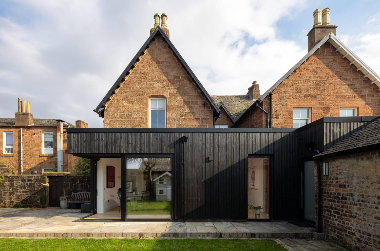 Contemporary black bi-folding doors installed at Main Street, Uddingston, enhancing home aesthetics and functionality with seamless indoor-outdoor access.